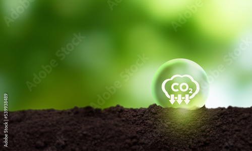 Reduction of carbon emissions, carbon neutral concept. Net zero greenhouse gas emissions target. Reducing carbon footprint concept. Decreasing CO2 emissions target symbol on green view background.