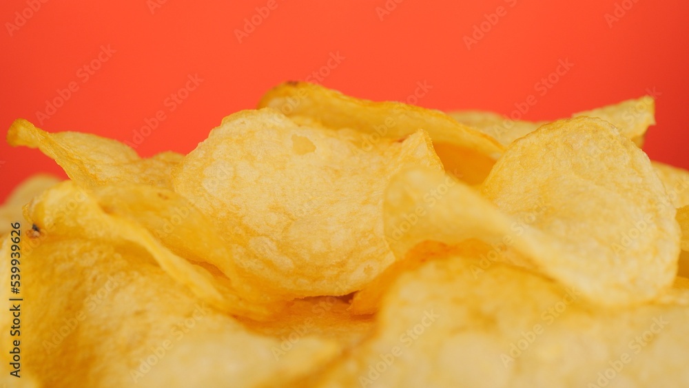 Potatoes chips, isolated on red background Potatoes chips, isolated on red background