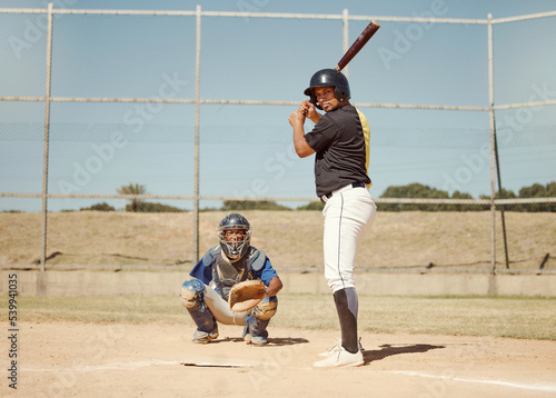 Baseball, pitcher and man with a bat on pitch playing a match or sport training as a team. Fitness, sports and men athletes practicing pitching and batting before a softball game on an outdoor field.
