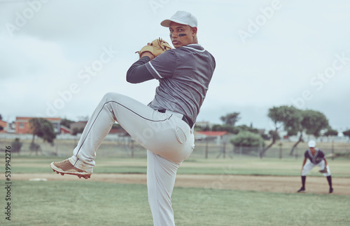 Baseball, sports and man throwing a ball during a professional game on a field with a team. Athlete pitching during an event for sport, competition or training with focus, balance and speed at a park