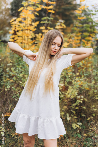 Outdoor atmospheric lifestyle portrait of young beautiful blondie lady. Warm autumn. Beautiful cheerful blondie woman 