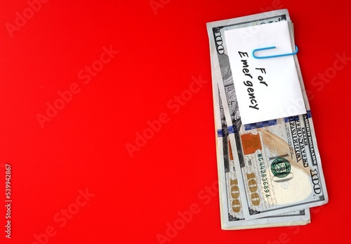 Canvas Print White paper note with text written FOR EMERGENCY  clip with cash dollars money o