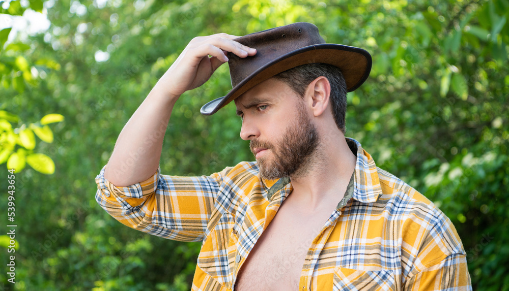 adult man in cowboy hat. sexy cowboy in checkered shirt. western cowboy wearing hat