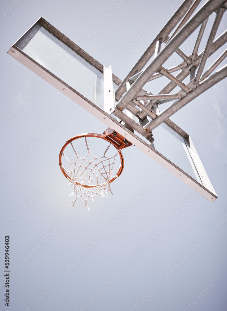 Basketball, sports and net with a hoop on a court on a cloudy day from below for training or exercise. Fitness, workout and health with sport equipment outdoor for practice or a competitive game