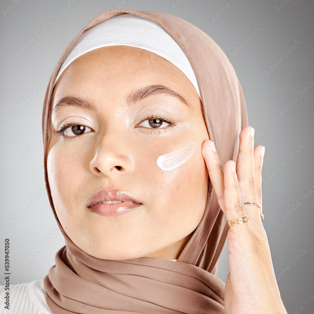 Muslim, beauty and skincare woman with cream on face product against a 