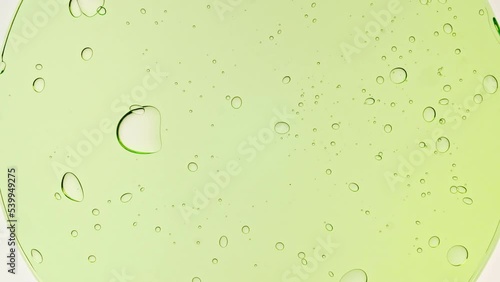 Transparent Green Cosmetic Gel Fluid With Molecule Bubbles and Oil on White Background. Macro shot. Production Close-up. Slow Motion. High quality 4k footage