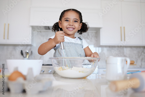 Happy girl kids baking in kitchen, house and home for childhood fun, learning and development. Smile young toddler child, little cooking chef and mixing bowl, sweets dessert, cookies and cake flour