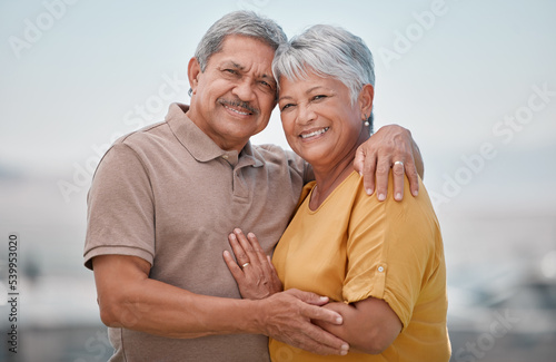 Happy, love and portrait of a senior couple in retirement, bonding and embracing in nature. Happiness, smile and elderly man and woman from Puerto Rico hugging with care, romance and joy outdoors.