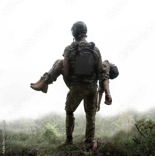 Photo The commander carries a wounded soldier