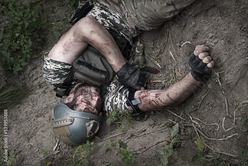 A wounded soldier stops the bleeding photo