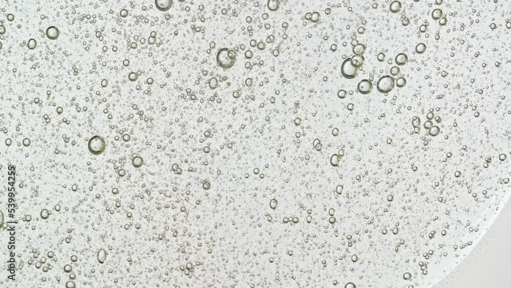 Transparent Cosmetic Gel Fluid With Molecule Bubbles Flowing On The Plain White Surface. Macro Shot of Natural Organic Cosmetics, Medicine. Production Close-up. Slow Motion. High quality 4k footage Transparent Cosmetic Gel Fluid With Molecule Bubbles Flowing On The Plain White Surface. Macro Shot of Natural Organic Cosmetics, Medicine. Production Close-up. Slow Motion. High quality 4k footage