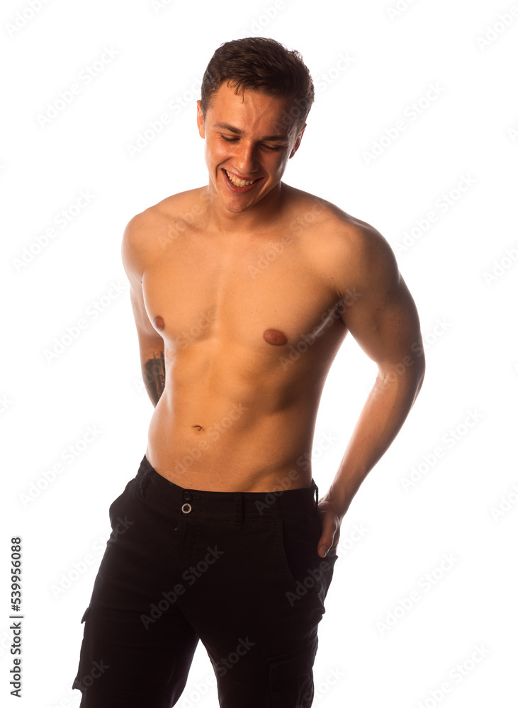 Smiling shirtless muscular man standing over white background