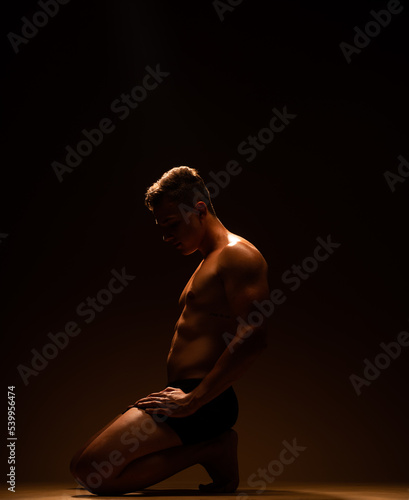 Silhouette of a man on his knees