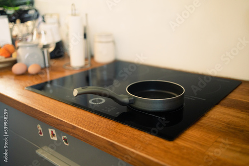 Frying pan in modern kitchen with induction stove. High quality photo