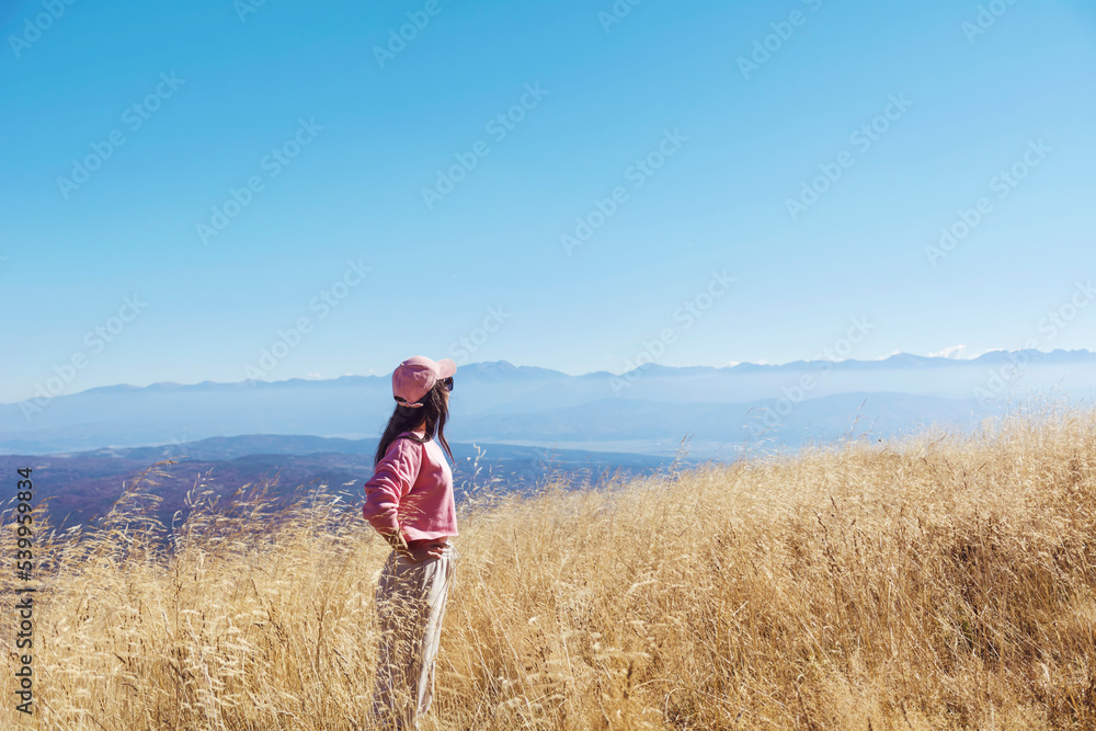 Young woman walking outdoor in the autumn mountain 