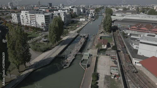 Weir or dam of Saint-Denis canal, Quai Josette at Aubervilliers in France. Aerial drone panoramic view photo