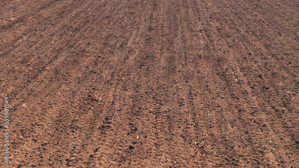Ploughed soil in perspective as background, drone pov Ploughed soil in perspective as background, drone pov
