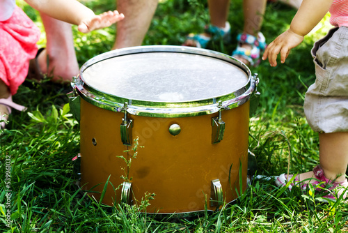 Group of children near the drum on the grass