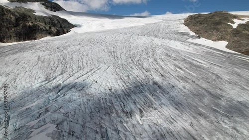 Shadows of clouds move over the Hardangerjokulen glacier in Norway. Drone shot photo