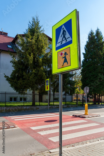 Road signs pedestrian crossing and children attention in Poland on the road in Krakow on a sunny day. Polish road signs. Vertical Orientation