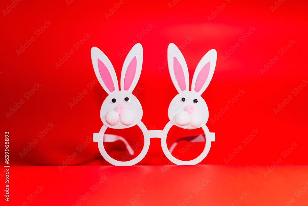 Two Toy Rabbit Bunny symbol of new year 2023 on red background.Christmas or New Year concept.Copy space.