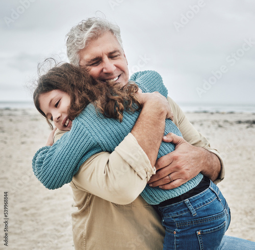 Foto Happy, grandfather and child hug on beach for love, care and family bonding in the outdoors