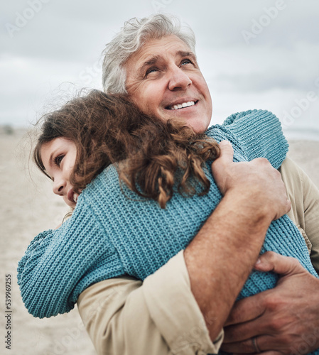 Fotografía Family, children and hug with a girl and grandfather embracing on the beach outdoor during a holiday or vacation