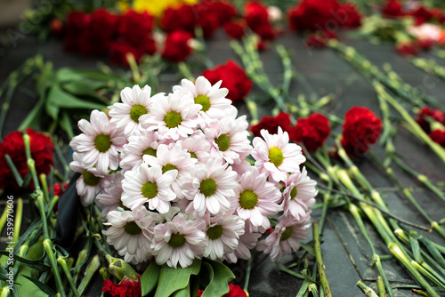 Flowers on memorial. Bouquet of flowers on gravestone.
