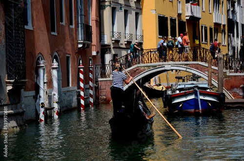female gondolier drives a gondola in a Venice