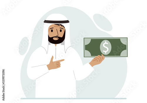 A arab man holds a large paper bill in his hand. The concept of income, expense, earning or spending money.