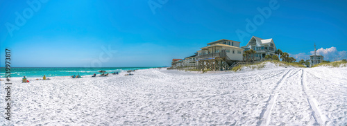 Beach houses with people at the front near the water on a beach at Destin, Florida