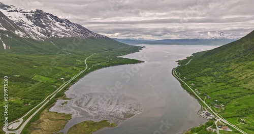 Nordkjosbotn Norway v3 drone flyover water inlet in between mountain valley capturing pristine nature landscape with mountaintop covered in snow on a cloudy day - Shot with Mavic 3 Cine - June 2022 photo