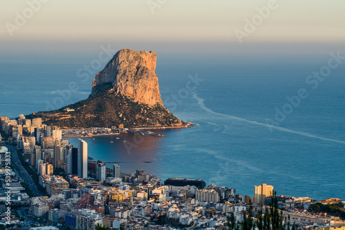 Fototapeta Naklejka Na Ścianę i Meble -  top view of the city of Calpe, the rocks of Ifach and the sea in the evening at sunset