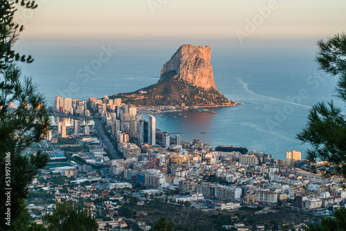 top view of the city of Calpe, the rocks of Ifach and the sea in the evening at sunset