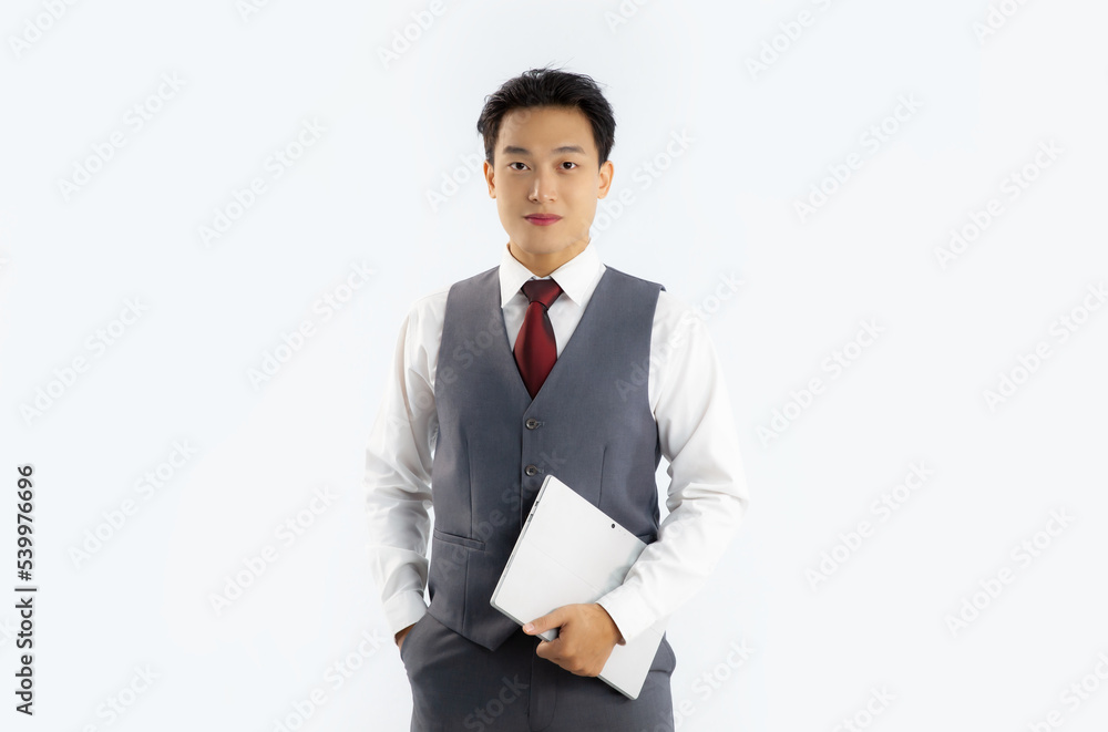 Portrait of asian businessman in vest suit holding tablet looking camera on white background.
Portrait of asian businessman in vest suit holding tablet looking camera on white background.