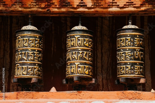 Closeup shot of Tibetan Buddhist ritual prayer wheel at Ghar Gumba monastery in Nepal photo