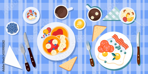 Vector illustration of a delicious breakfast for two. View from above. Plates with scrambled eggs, bacon and a plate with pancakes, fruits and berries. Breakfast with a cup of tea or coffee. 