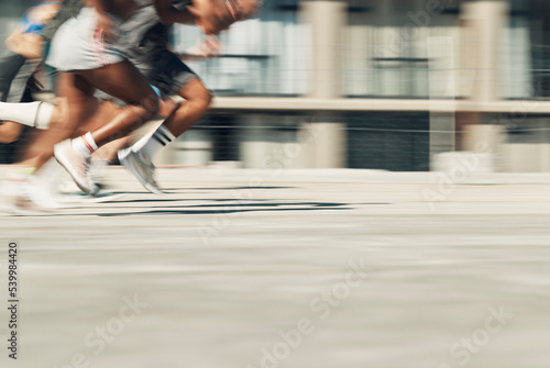 Sports race, running and sprint competition of fast athlete people or runners on concrete city road for workout, training and fitness. Feet of men and woman outdoor for marathon, speed and energy run