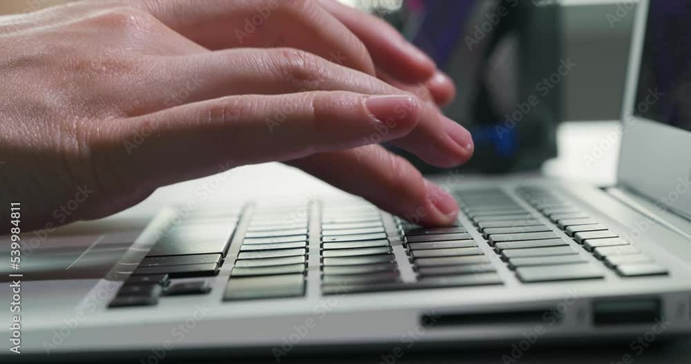 Female hands typing on laptop keyboard, closeup Female hands typing on laptop keyboard, closeup