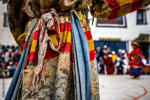 Old colorful cloth of an Ancient Tibetan Buddhist dancer at Tiji festival photo