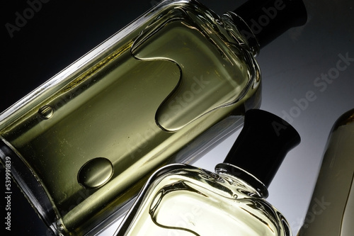 transparent jars with perfume lie on a light background. Close-up