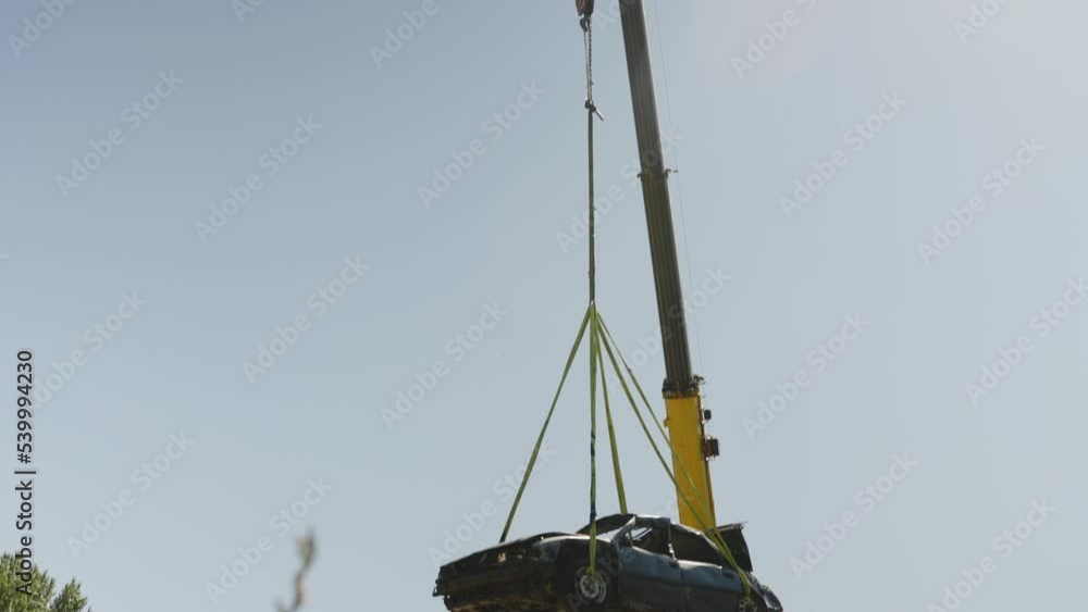 Hanging scrapyard junk car from a tower crane 
