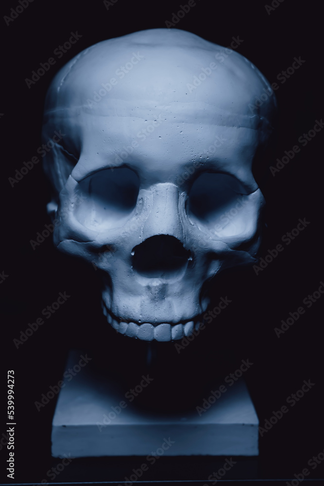 Obraz premium Human skull made of concrete on a stand. Interior decor.