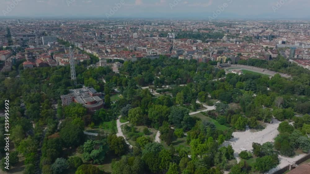 Aerial view of vegetation in Sempione Park and town development in metropolis in background. Milano, Italy Aerial view of vegetation in Sempione Park and town development in metropolis in background. Milano, Italy