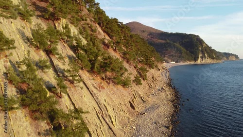 Coastline of rocky shore and blue sea, drone flight