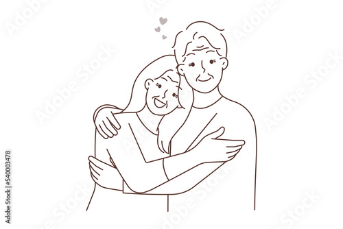 Happy elderly couple hugging