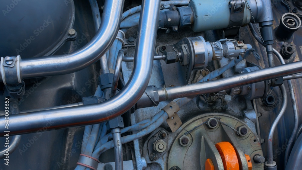 Close-up of the engine's complex mechanics and stainless steel piping for supplying fuel to the combustion chamber and coolant, as well as lubricating the bearings. Close-up of the engine's complex mechanics and stainless steel piping for supplying fuel to the combustion chamber and coolant, as well as lubricating the bearings.