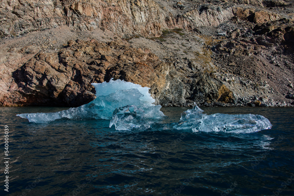 Piece of ice in clean water. Iceberg. Piece of ice in clean water. Iceberg.