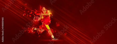 Creative artwork. Sportive man, basketball player in motion over red background with polygonal and fluid neon elements.