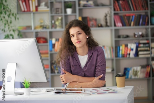 Beautiful business woman sitting in office and working on pc